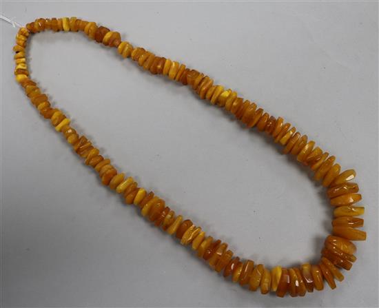 A single strand jagged amber bead necklace, gross weight 74 grams, 64cm.